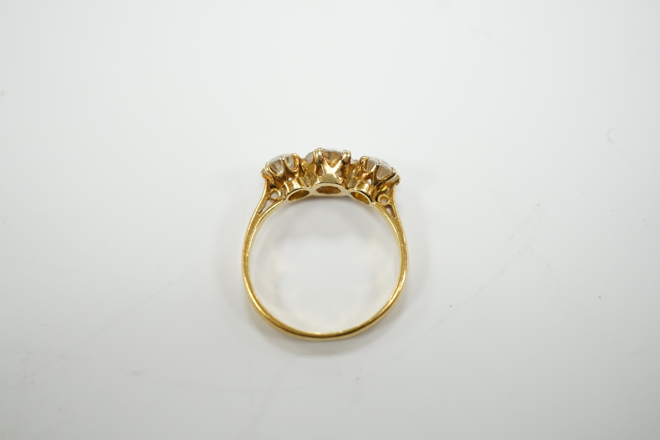 A George V 18ct gold and three stone diamond set ring, the central stone weighing approx. 0.60ct, size L, gross weight 2.5 grams.